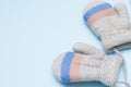Gray child mittens on blue background, copy space. winter cloth Royalty Free Stock Photo