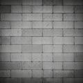 Gray cinder block wall showing a uniform pattern of rectangular blocks. Each block Royalty Free Stock Photo