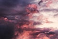 Gray clouds sky background with red light from sun. Royalty Free Stock Photo