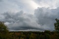 Gray clouds in the sky over green forest Royalty Free Stock Photo