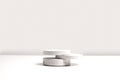 Gray cocncrete circle shaped pedestals on white table with copy space, side view. Podium mockup background for products Royalty Free Stock Photo