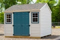 Gray color prefab gardening tools storage shed in the house backyard nature dress facade Royalty Free Stock Photo