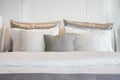 Gray color scheme pillows setting on bed with satin finished bedding