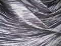 Gray compressed silk in folds.