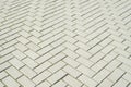 Gray concrete block pavement in herringbone pattern on sidewalk closeup Royalty Free Stock Photo