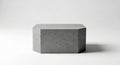 A gray concrete cube with a rough texture sits on a white surface with shadow Royalty Free Stock Photo