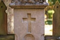 gray concrete fence post with a cast cross and wooden posts on the sides Royalty Free Stock Photo