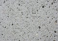 Gray concrete texture featuring numerous small, irregular holes. The surface has a Royalty Free Stock Photo