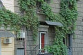 Gray concrete wall of a house with windows and a white door Royalty Free Stock Photo