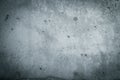 Gray concrete wall texture surface dark background with vignetting. A coarse facade made of natural cement with holes imperfection