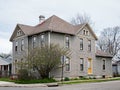 Gray Corner House with Large Bush