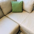 Gray corner sofa with green cushion