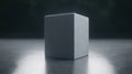 A gray cube with a rough texture sits on a reflective surface.