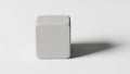Cube casts a subtle shadow on the surface suggesting a light Royalty Free Stock Photo