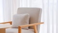 Gray cushion on armchair in front of white curtain inside of modern living room Royalty Free Stock Photo