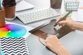 The gray desk with laptop, notepad with blank sheet, pot of flower, stylus and tablet for retouching Royalty Free Stock Photo