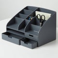 Gray desk organizer with multiple compartments and two shallow drawers. Contains Royalty Free Stock Photo