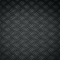 Gray diamond plate with a raised pattern of alternating groups of parallel lines. Royalty Free Stock Photo