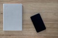 Gray Diary with Black Phone on Old Wood Table. Royalty Free Stock Photo