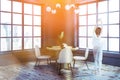 Gray dining room corner, beige chairs, woman Royalty Free Stock Photo