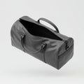 Gray Duffel Bag Partially Open on a White Background with Studio Lighting and Textured Surface Royalty Free Stock Photo