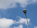 gray electric pole against white cloud sky