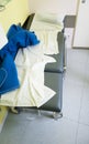 gray empty couch for sick patient examination. Crumpled disposable sheets after the patient