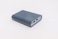Gray external battery lies on a light isolated background. Royalty Free Stock Photo