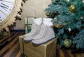 Gray felt boots under the Christmas tree and Christmas boxes with gifts Royalty Free Stock Photo