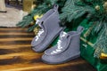 Gray felt boots under the Christmas tree and Christmas boxes with gifts Royalty Free Stock Photo