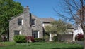 Gray Flagstone House with Large Chimney and White Trim