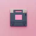 Gray retro floppy disk with pastel pink backdrop Royalty Free Stock Photo