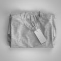 Gray folded T-shirt with labels. 3d rendering, mockup. Royalty Free Stock Photo