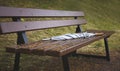 Gray forgotten umbrella walking stick rain on a bench in autumn Park, close up