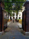 Gray Friars church yard, a London park, with empty seats and clear, central lanterns and graves full Royalty Free Stock Photo