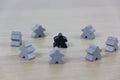 Gray gaming pieces and a black meeple, diversity concept