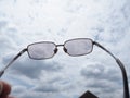 gray glasses and gray white clouds sky