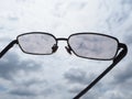 gray glasses and gray white clouds sky