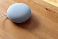 Gray Google Nest Mini on a wooden table