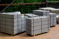 Gray granite border piled in a pile on a pallet for transportation.