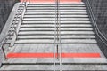 Gray granite staircase with steps and stainless steel handrail descent into the underpass. Royalty Free Stock Photo