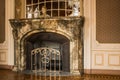 Gray granite stone fireplace in the luxury room of a rich mansion. interior of the hall. baroque style Royalty Free Stock Photo