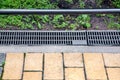 Gray grating of the drainage system for drainage of rainwater. Royalty Free Stock Photo