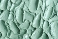 Gray green bentonite facial clay alginate mask, face cream, body wrap texture close up, selective focus. Abstract background Royalty Free Stock Photo