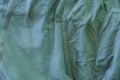 Gray green fabric texture of a crumpled piece of cloth Royalty Free Stock Photo