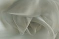 Gray or green organza fabric. Crumpled or wavy fabric texture background. Abstract linen cloth soft waves. Natural yarn