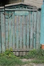 gray green rural wooden fence wall and closed old one door Royalty Free Stock Photo