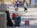 Gray-haired elderly man-guitarist, plays guitar outdoors