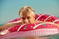 Gray-haired funny man swims on an inflatable circle in sea Royalty Free Stock Photo