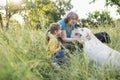 Gray-haired grandmother and cute little granddaughter are walking their dogs together in the park Royalty Free Stock Photo